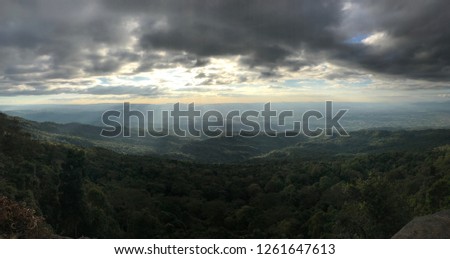 Scenic view of the green mountain against the light rays shine through the clouds
