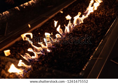 Close view at flames of fire at decorative table top fireplace. 