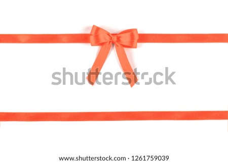 Shiny red silk ribbon isolated on white background. Festive concept. Flat lay.