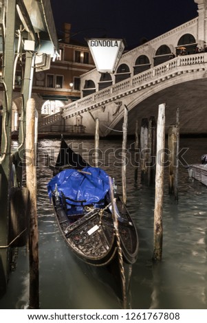 Gondola parking near the famous Realto bridge on a Grand Canal in Venice, Italy