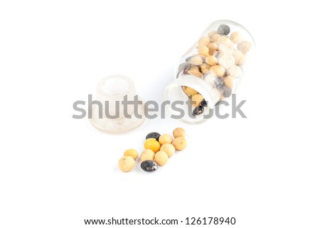 yellow and black soybean seeds in a glass bottle with white background studio shoot
