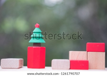 Miniature Christmas tree put on wooden block for Celebrate Christmas on December 25 every year. Concept of Celebrate Christmas