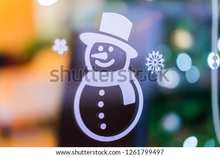 Christmas snowman on the glass