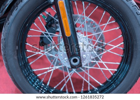 front wheel motorcycle. Closeup of motorcycle front wheel and spokes with focus on center wheel disk