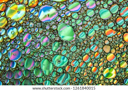 Abstract background of oil bubbles floating on water