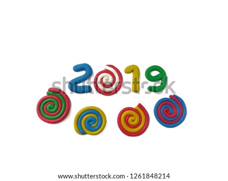 Colorful plasticine clay made are number year 2019 text and variety color spiral shape on white background, festival are dough