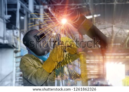 Industrial Worker laborer at factory welding process and welding spark light with steel on structure pattern background concept