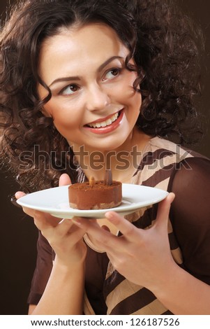 The beautiful smiling young woman with a cake