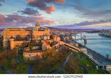 Budapest, Hungary - Golden sunrise at Buda Castle Royal Palace with Szechenyi Chain Bridge, Parliament and colourful clouds Royalty-Free Stock Photo #1261912960