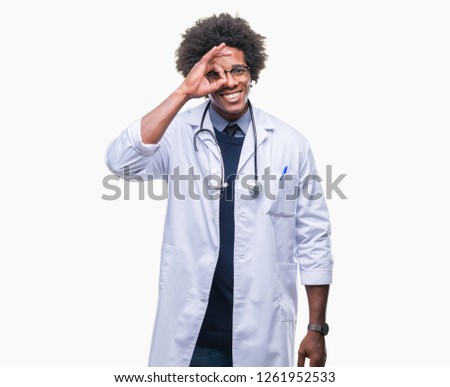 Afro american doctor man over isolated background doing ok gesture with hand smiling, eye looking through fingers with happy face.