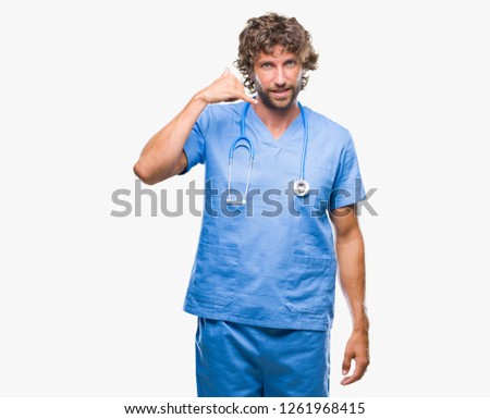 Handsome hispanic surgeon doctor man over isolated background smiling doing phone gesture with hand and fingers like talking on the telephone. Communicating concepts.