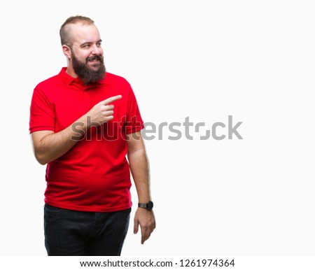 Young caucasian hipster man wearing red shirt over isolated background cheerful with a smile of face pointing with hand and finger up to the side with happy and natural expression on face