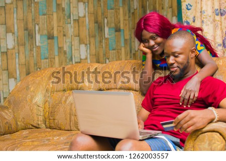 Couple buying things online with their card on their laptop