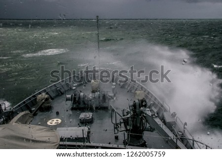 Ship in sea storm. Storm at Baltic sea. Warship training in the Baltic Sea during a storm. Military ship in Baltic sea, Latvia. Military ship during a storm. view from ships the bow.