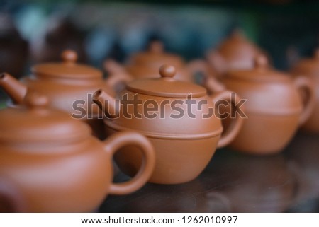 Chinese brown clay pot in shop closeup photo