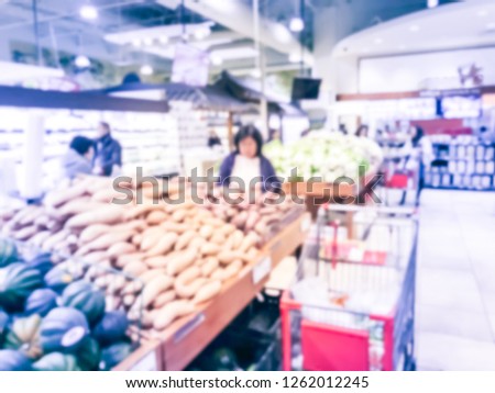 Vintage tone blurred motion customer shopping for fresh produces, fruits, vegetables at Asian supermarket in Texas, USA.
