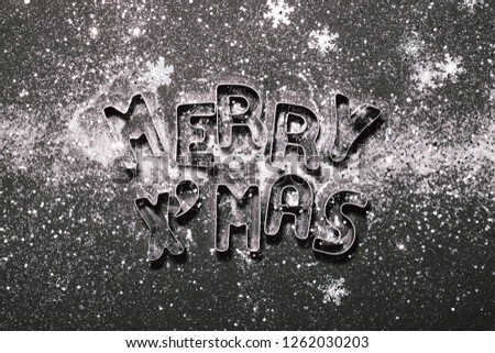 Merry Xmas letters on snowy black background. Holiday Christmas concept. Greeting card.