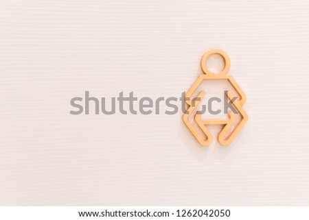 Baby or babie toilet signs on a white wall. Gender social and cultural issues concept luxury background.
