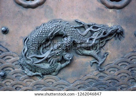 A low relief sculpture depicting image of sea dragon decorated on the temple pillar