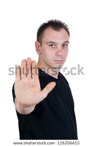 young man with blue eyes makes stop gesture / holds up hand - isolated on white background