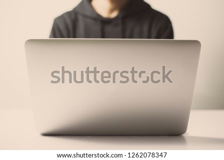 Hacker in front of the laptop computer.