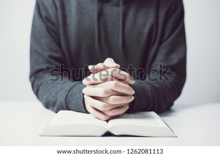 Man is praying on the white table.