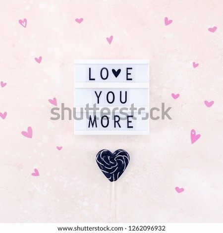 Creative Valentine Day romantic composition flat lay top view love holiday celebration with black heart lightbox pink background copy space Template greeting card text design social media blogs