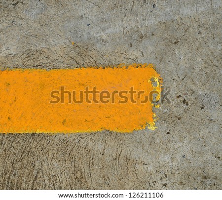 part of yellow arrow on the road