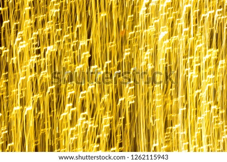 Abstract bright yellow lights for background. Decorative lights. Long exposure lights.
