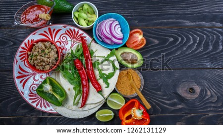 Burrito Fixings. Mexican chicken burrito bowl with onions, minced, beans, corn tomato, avocado chili. Taco salad lunch bowl.