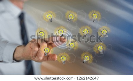 Man touching light bulbs on a touch screen with his finger