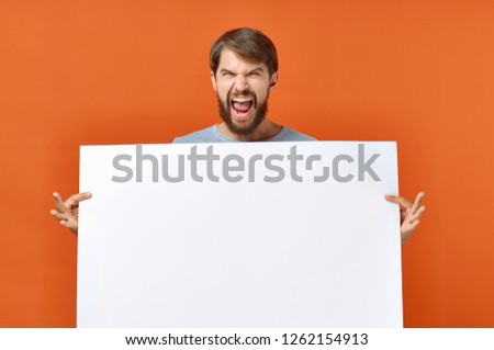 aggressive man with a white sheet of paper on an orange background, Poster mockup               