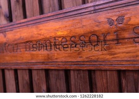 Wooden sign with the inscription montessori engraved on it.