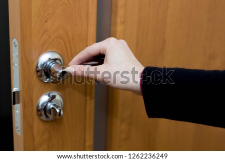 Female hand opens the interior door close-up