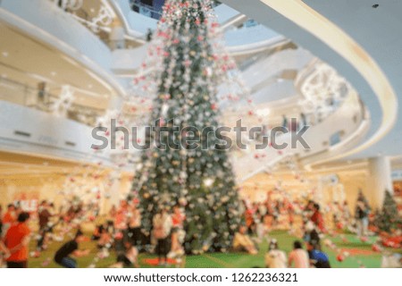 Abstract blur image of people walking at shopping mall or exhibition hall with bokeh for background usage . Blurry colorful of happy festival theme with bokeh. Beautiful background of New year.