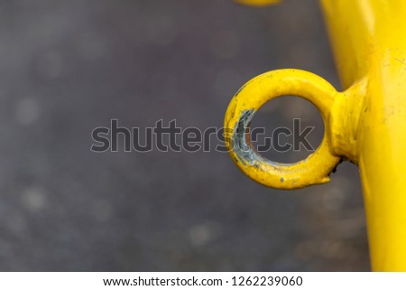 Yellow iron pipe There is a circle loop attached. Put on playground outdoor.