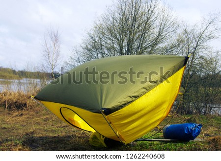 Spring wind flurry. A gust of Wind overturned the open tent on the Bank of the forest river