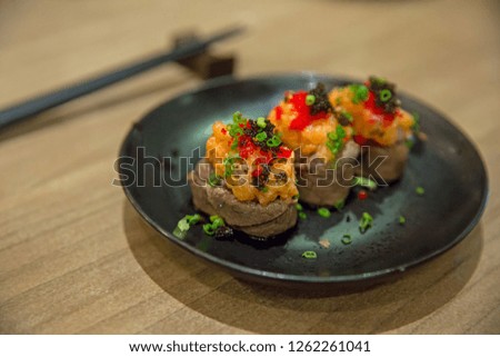 Slice Grilled Wagyu Sushi Sprinkle with vegetables and shrimp eggs.
