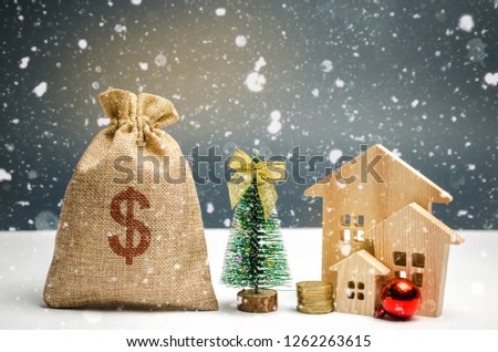 Wooden houses and Christmas tree and a bag of money. Christmas Sale of Real Estate. New Year discounts for buying house. Purchase apartments at a low price. Winter resort and vacation. Dollar sign