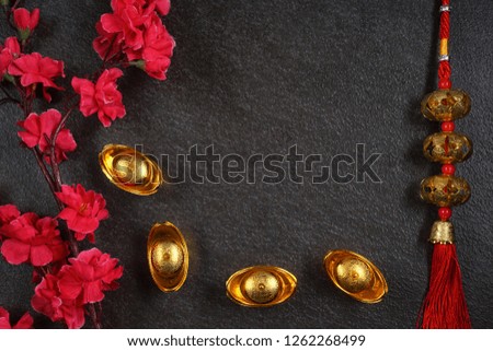 Chinese New Year flat lay background with festival decorations on dark grey background. Chinese characters means luck and prosperity. Top view or flat lay.