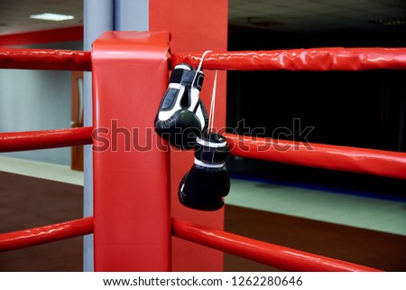 Boxing gloves on boxing ring in gym