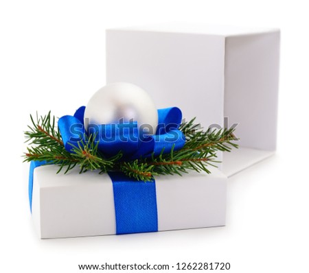 White gift box with blue ribbon and toy isolated on white color background