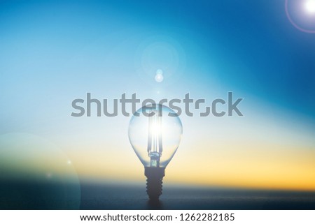 led lamp against the background of the silhouette of the layout of the house on a blue background. 