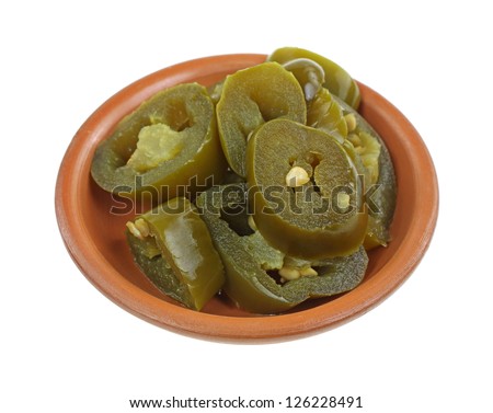A group of jalapeno pepper slices in a small ceramic dish.