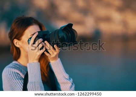 Woman photographer in nature with a camera                   