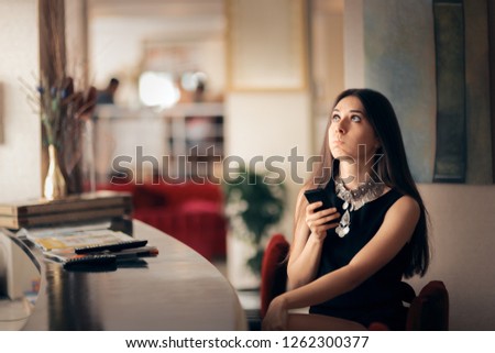 Funny Bored Woman Holding Smartphone Waiting for her Date. Unhappy stood-up girl checking her phone for apology message