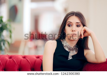 Funny Bored Elegant Woman Waiting in Hotel Lobby. Unhappy stood-up girl tired of waiting on a couch
 Royalty-Free Stock Photo #1262300380