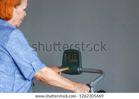 Senior woman playing sports on an electronic treadmill