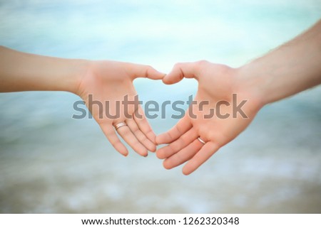 The hands of two lovers: man and woman make heart shape image. Couple lovers holding hands,  gently, affectionately, with love and  Celebration valentine's day, spend honeymoon picture.