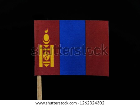 A interesting and unique flag of Mongolia on woodpick on black background. A vertical triband of red and blue with the Soyombo symbol centred on the hoist-side of the red ban.